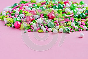 Multi-colored Sugar sprinkle dots, decoration for cake and bekery in pink background. Easter. Copy space