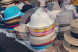 Multi-colored summer hats on the market counter