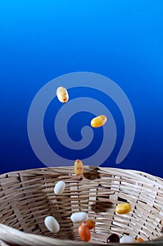 multi colored sweets failing in a cane fruit bowl