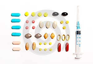 Multi-colored tablets and prick, vitamins, dietary supplements