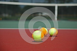 Multi-Colored Tennis Balls on Hard Court