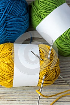 multi-colored threads for knitting and knitting needles. Selection of colorful wool yarn. Yarn for knitting winter