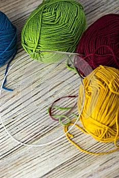 multi-colored threads for knitting and knitting needles. Selection of colorful wool yarn. Yarn for knitting winter