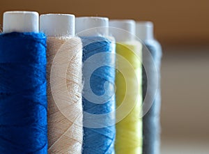 multi-colored threads on spools close-up