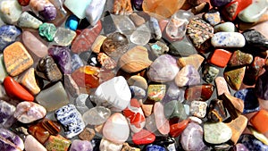 Multi-colored tumbled assorted stones turn around