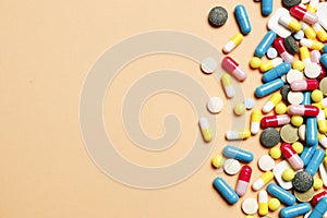Multi-colored vitamins on a pink background