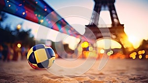 A multi-colored volleyball lies on sand against the backdrop of the Eiffel Tower during sunset, Summer Olympics in 2024