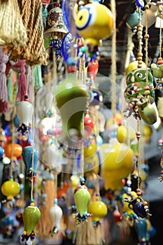 Multi-colored wall and ceiling retro ornaments, various ceramics and threads and trinkets hung on the wall