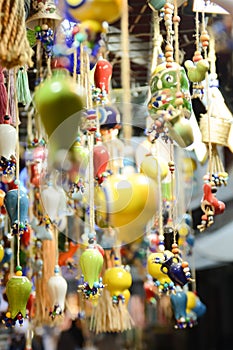 Multi-colored wall and ceiling retro ornaments, various ceramics and threads and trinkets hung on the wall