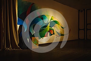 Multi-colored wall of the room with an abstract pattern and yellow highlights and shadows.