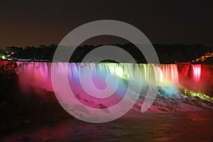 Multi colored water & light masterpiece performance, regular nightly illumination, at dusk in Niagara Falls between USA & Canada