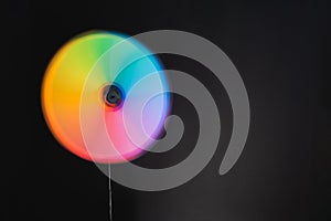 Multi-colored wind toy on a black background