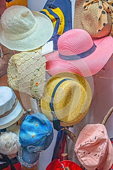 Multi-colored women`s hats in the shop window