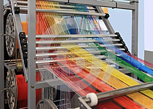 Multi-colored yarns in the textile machine photo