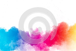 Multi colour powder explosion on white background. Launched colourful dust particles splashing