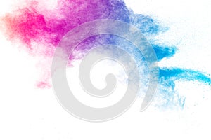Multi colour powder explosion on white background. Launched colourful dust particles splashing