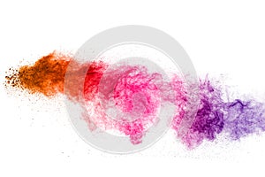 Multi colour powder explosion on white background. Launched colourful dust particles splashing