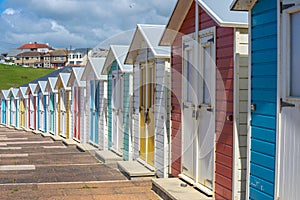 Multi coloured beach huts facing the beach at Bude, Cornwall UK July 6 2020