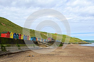 Multi-coloured beach huts on Whitby West Cliff, Whitby, North Yorkshire