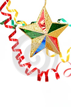 Multi-coloured celebratory tinsel and christmas star on a white