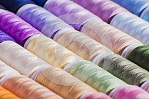 Multi-coloured cotton reels arts and crafts background