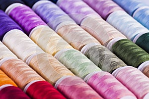 Multi-coloured cotton reels arts and crafts background