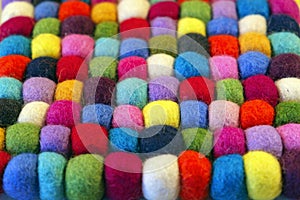 Multi coloured felt bobble table mat