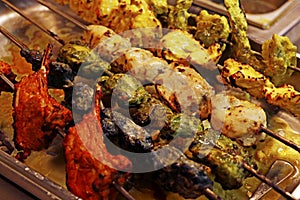 Multi coloured and flavoured indian tandoori kebabs or tikka in a skewer, authentic cuisine