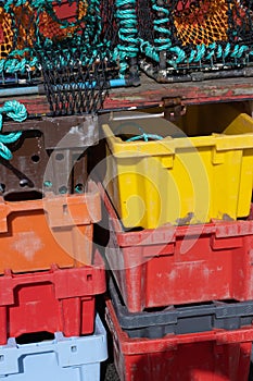 Multi coloured plastic boxes on fishing boat