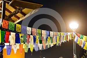 Multi-coloured rag tags of a garland are hanged out on cords