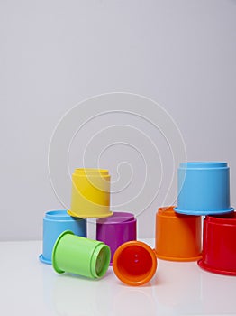 Multi-coloured stacking cups for a baby.balance concept
