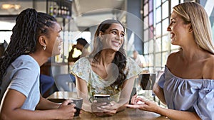 Multi-Cultural Group Of Female Friends Meeting And Catching Up In Restaurant Or Coffee Shop 