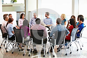 Multi-Cultural Office Staff Sitting Having Meeting Together