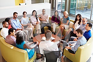 Multi-Cultural Office Staff Sitting Having Meeting Together