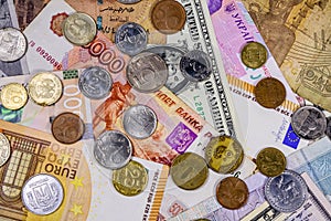 Multi currency background. Euro, american dollars, ukrainian hryvnias, egyptian pounds, russian roubles, different coins