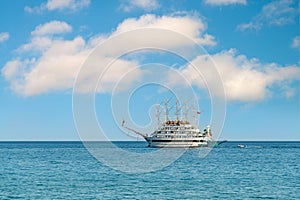 Multi-deck excursion boat taking tourists around on a sunny day