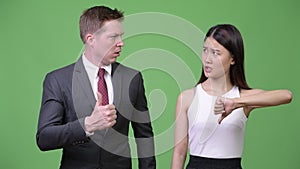 Multi-ethnic business couple having different decisions