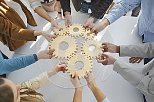 Multi-Ethnic business people connect gear together, success cooperation teamwork concept.