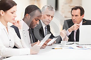 Multi ethnic business people discussing work