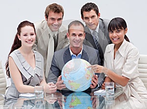 Multi-ethnic business team holding a terrestrial g