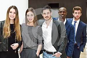 Multi-ethnic business team standing in an office building