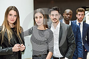 Multi-ethnic business team standing in an office building