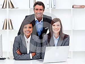 Multi-ethnic business team working at a computer