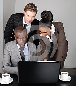 Multi-ethnic business team working on laptop