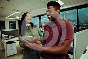 Multi-ethnic co-workers smiling for successfully finishing business report ready to enjoy their weekend