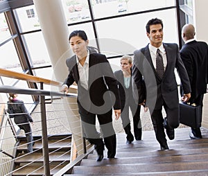 Multi-ethnic co-workerson busy office stairs