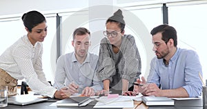 Multi ethnic company workers group brainstorm at office meeting table