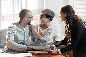 Multi-ethnic couple feels satisfied with negotiations results with agent