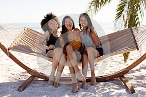 Multi ethnic group of female sitting on a hammock