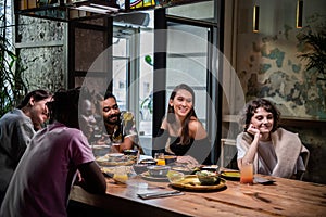 Multi-ethnic group of friends having a good time in a cafe